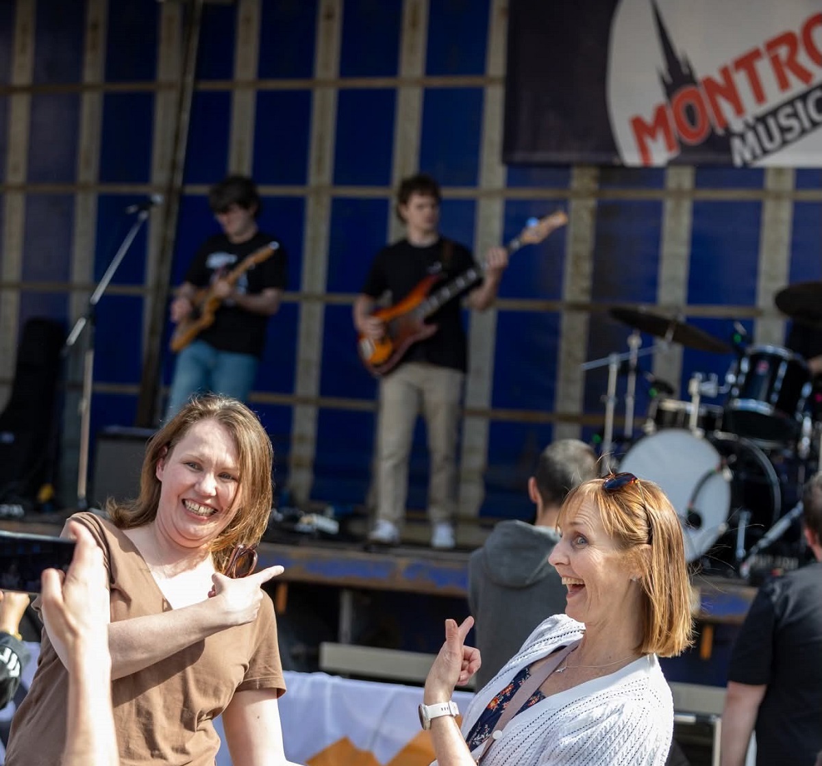 Ladies having fun listening to local bands at the Montrose music festival